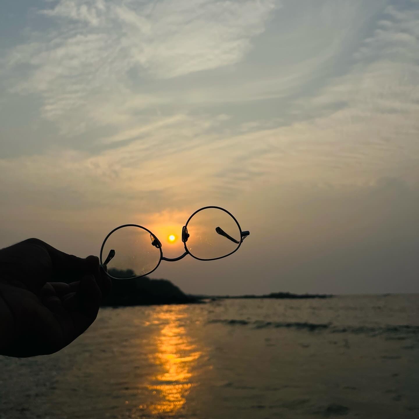 Sunset framed through a pair of glasses