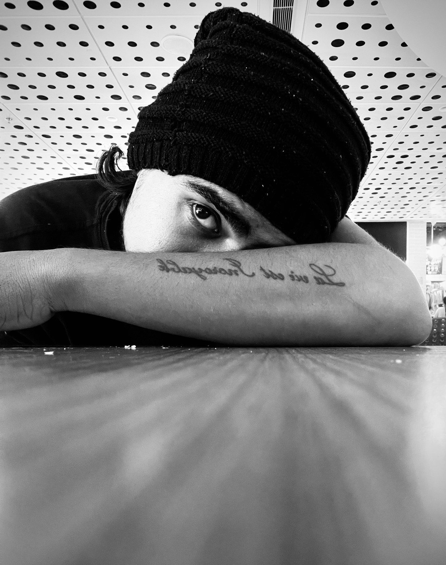 Black and white portrait, composed low to the table